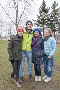 From left, Friends of the Beach Parks members Skye Vandenberg, Alex Rochon-Terry, Joycle McLean and Adele Gendron huddle on an unusually cold April 23 day at the spot in Ashbridges Bay Park where they are planning a community garden that will grow fresh food and pollinating plants in warmer weather. PHOTO: Andrew Hudson