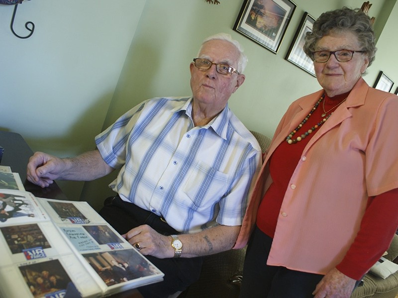 Bill and Mary Hall take a look through some of Bill’s often metaphorical photographs at their home Jan. 18.