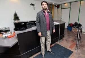 Anil Narayan, general manager of the Crescent Town Club, stands by the empty front desk of the popular recreation and community centre. The remains closed after a July 9 fire destroyed the building's electrical equipment, which has proved difficult to replace. PHOTO: Andrew Hudson