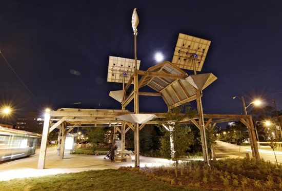 Sam Adatya and his family wait for a bus at a table under Dawes Crossing, a public art project at Dawes Road and Victoria Avenue designed by artist Noel Harding that officially opened on Saturday, June 22. Harding is likely best known in Toronto for The Elevated Wetlands, a set of six giant polystyrene structures that look like teeth or creatures, depending who you talk to, built in 1998 along the Don Valley Parkway. PHOTO: Andrew Hudson