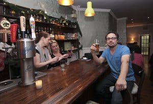 Robert Maxwell savours a craft beer at the official Dec. 6 opening of The Beech Tree pub on Kingston Road. With a menu inspired by English gastropubs and made from scratch by chef Jason Cox, Maxwell said the Beech Tree is an all-DIY effort that grew out of the small booth he ran at the Toronto Underground Market. PHOTO: Andrew Hudson