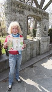 Beach artist Jennifer Cline displays her painting of the Kew Gardens war memorial. The painting will be sold to the highest bidder, with the funds going to a restoration of the cenotaph, along with adding names to recognize Canadian soldiers’ more recent contributions in peacekeeping missions and conflicts. PHOTO: Andrew Hudson