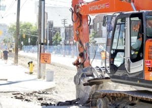 An excavator digs up asphalt along Kingston Road on July 24. PHOTO: Andrew Hudson