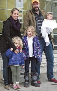 From left, Beach Metro volunteers Nadia and Michael Christie with their daughters, Emily, 3, Ella, 6, and four-month-old Josephine. PHOTO: Andrew Hudson