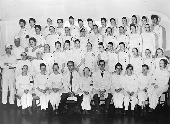 Mary Franklin poses with colleagues at the Pickering munitions plant in the 1940s. Franklin is standing in the third row from the front, fifth from the right. At its peak, the war-time munitions plant employed some 9,000 people, who came from all over Canada. PHOTO: Submitted