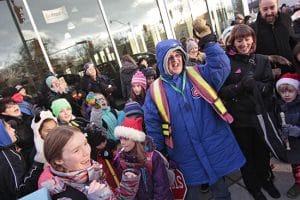 Crossing guard Raymond Monckton, known simply as 'Ray' among the many Gledhill elementary students he helped across Danforth Avenue for the last seven years, poses for a photo after local families surprised him with a retirement parade on Dec. 19. PHOTO: Andrew Hudson
