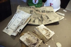 YMCA archivist Ian Fleming with elements discovered inside a time capsule buried in 1952.