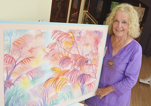 Painter and one of the founding members of the Beach Guild of Fine Art Jennifer Cline shows one of the paintings that will be available at the Guild’s Art in the Beach show. PHOTO: Jon Muldoon