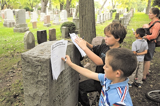 Isaac, front, and Jeremy consult their checklists during a scavenger hunt at St. John’s Norway Cemetery on Sept. 15. PHOTO: Jon Muldoon