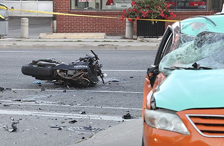 A major collision involving a motorcycle and a Beck taxi cab closed Danforth Avenue from Victoria Park Avenue to Pharmacy Avenue on the evening of Saturday , Sept. 26 while officers reconstructed the scene. PHOTO: John Hanley